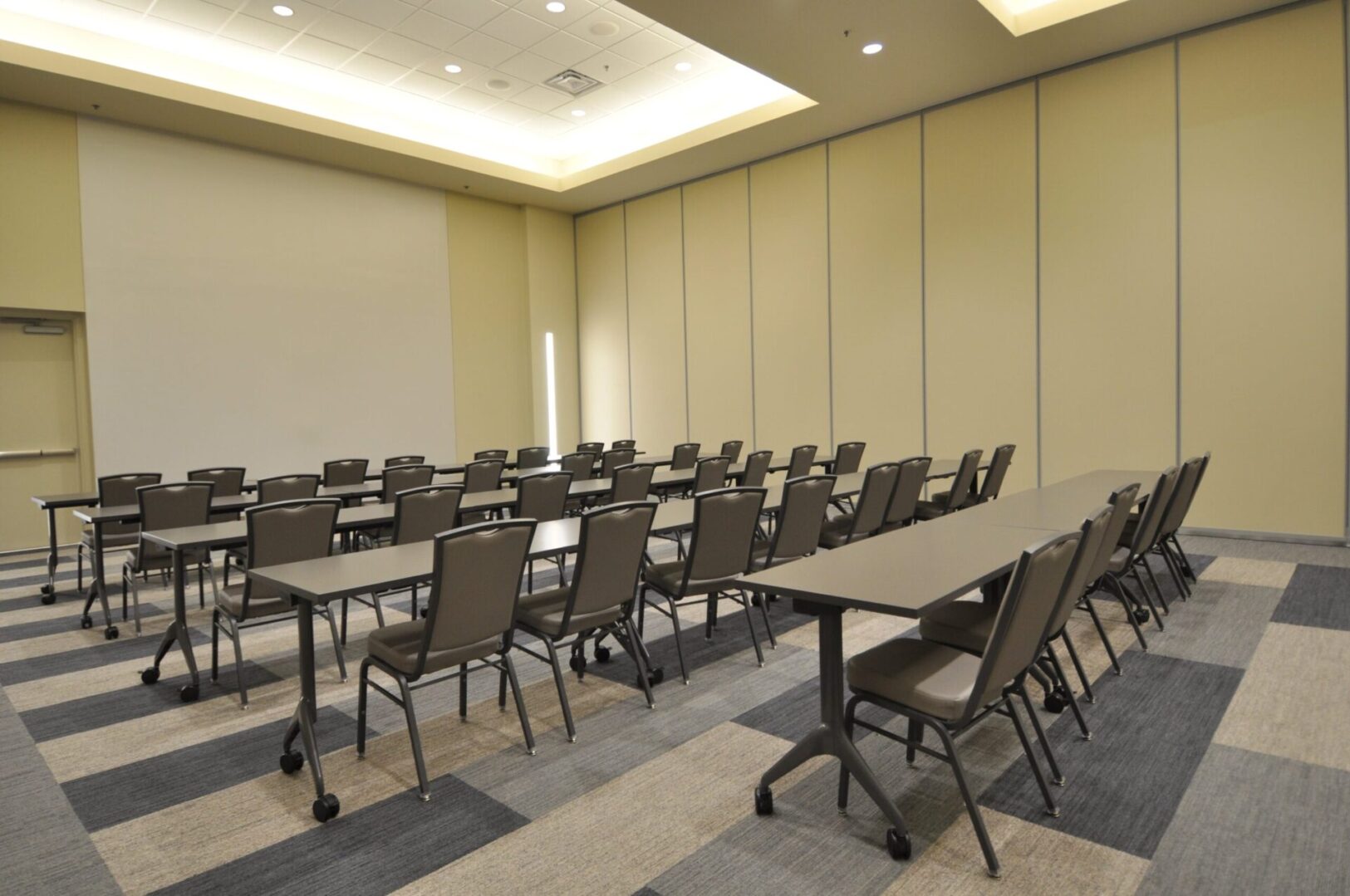 A room with many chairs and tables in it