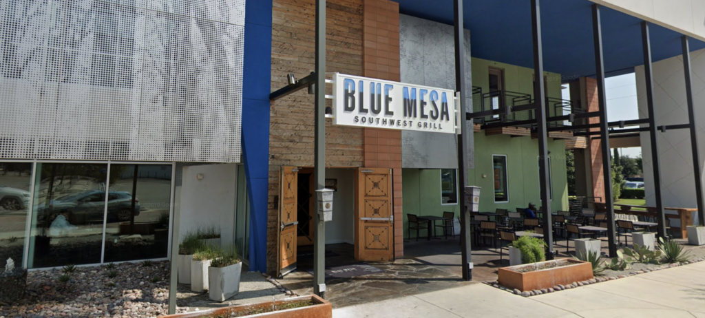 A restaurant with blue mesa southwest grill on the side.