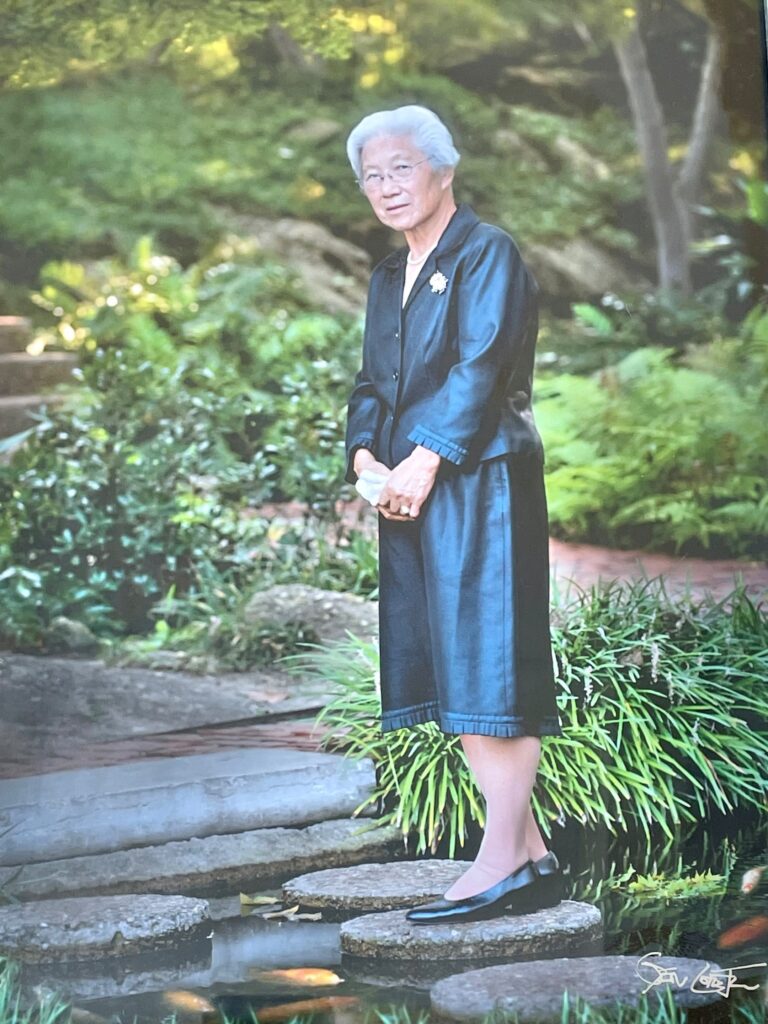A man in a robe standing on some steps