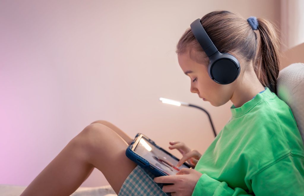 Girl in headphones on a tablet