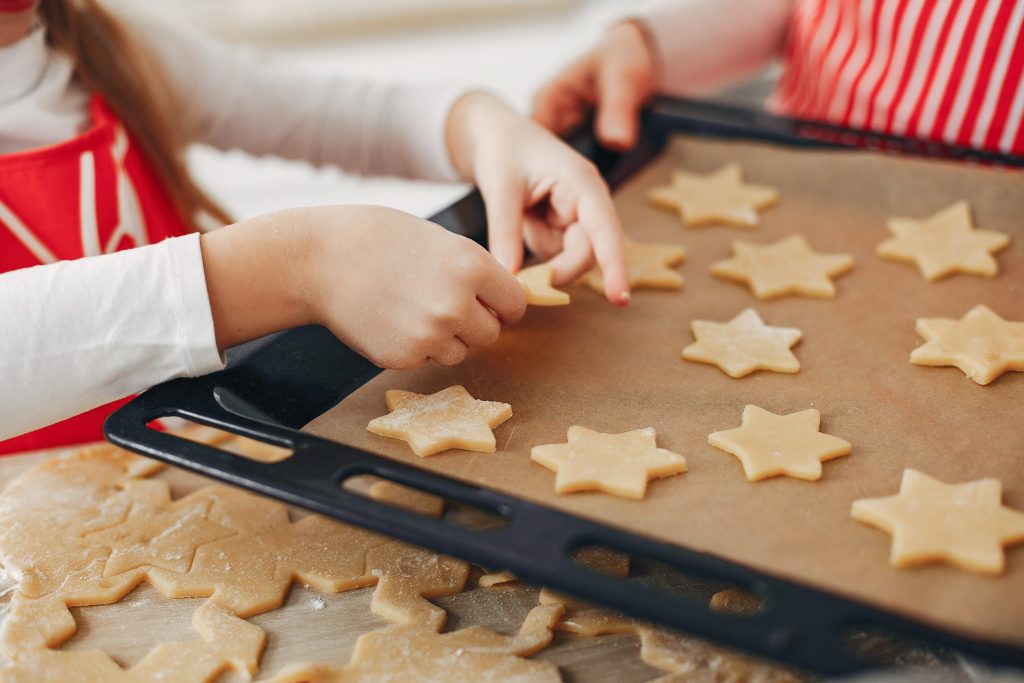 adult and child baking star shaped cookies
