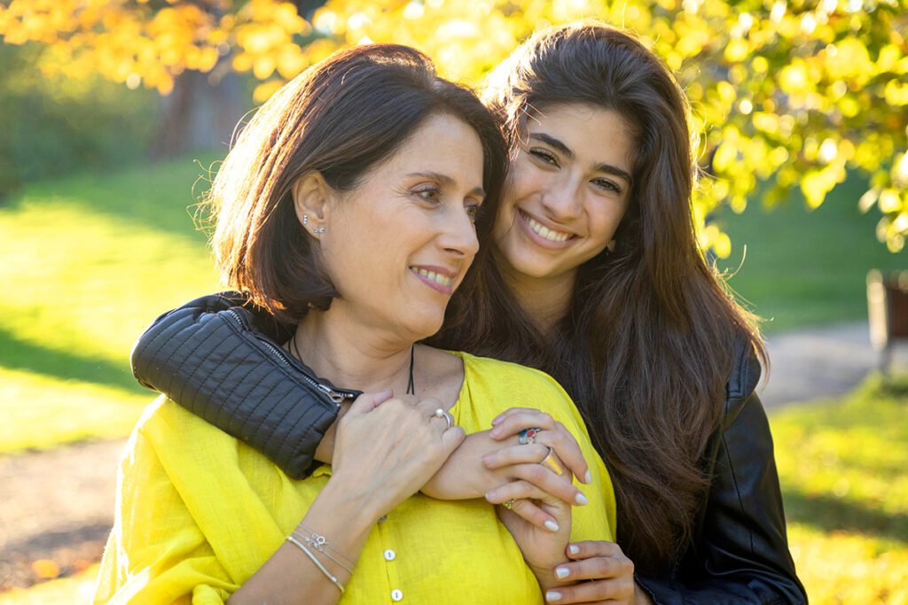 A woman and her daughter posing for the camera.