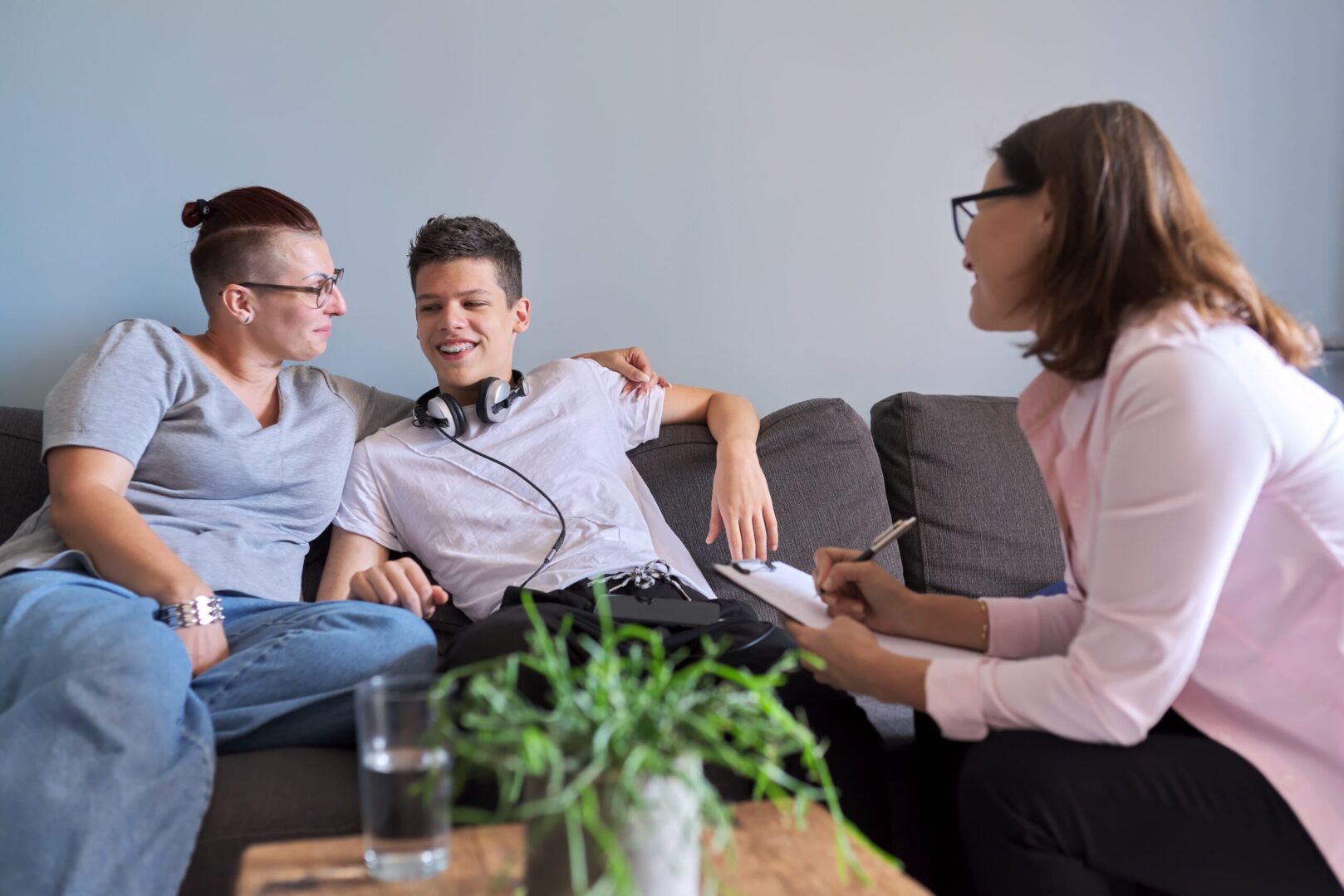 A group of people sitting on top of a couch.