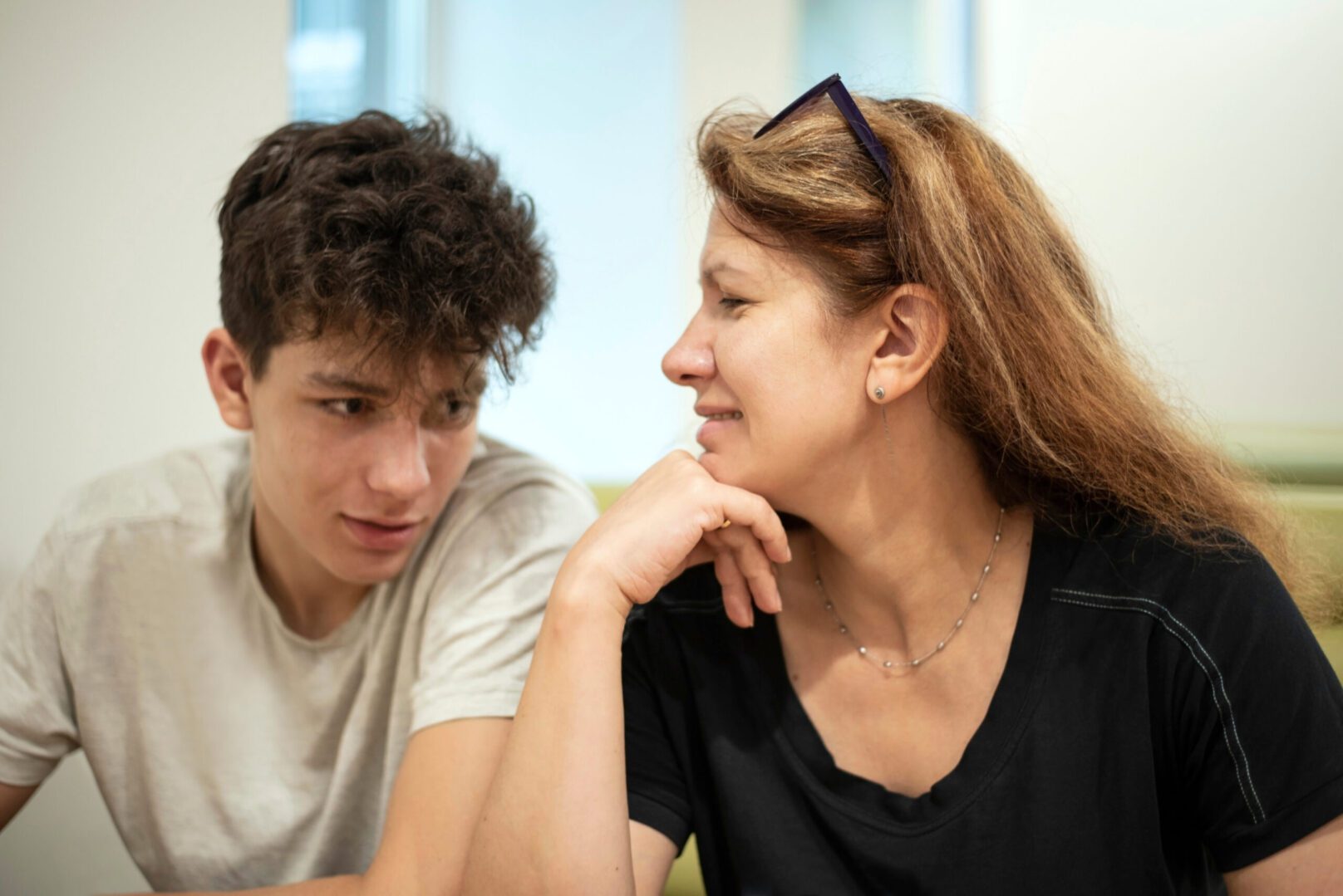 A woman and a boy are sitting together