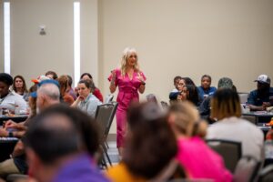 Taes Leavitt speaking in a room full of people
